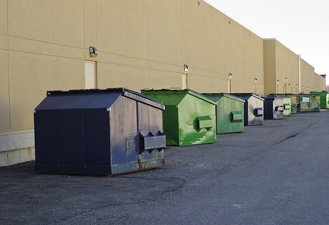 a collection of bright and vibrant dumpsters in a construction zone in Addison